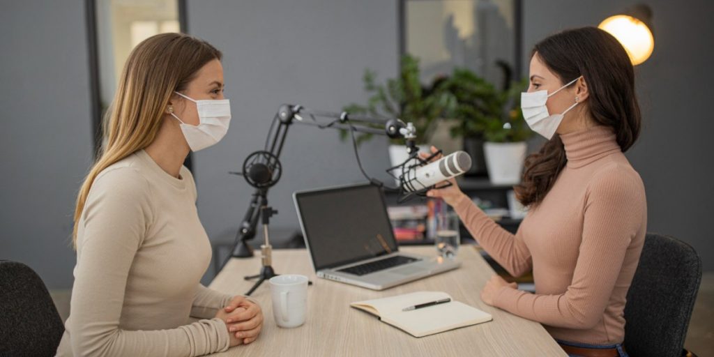 Foto de mulheres fazendo podcasts de medicina.